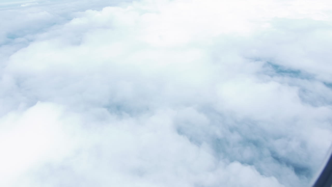 Outside View Of Clouds As Seen From The Window Of An Airplane Flying From Australia To Singapore - aerial, POV