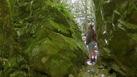 A-video-clip-of-a-man-walking-through-several-large-stones-that-are-covered-in-rocks