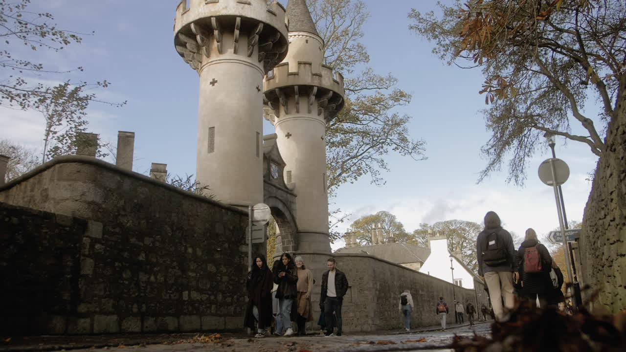 Group of young University students walking in slow motion at Aberdeen University.