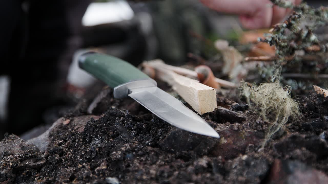 Close-up slow motion of knife by fireplace