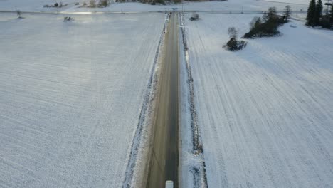 frozen winter road at sunset - aerial