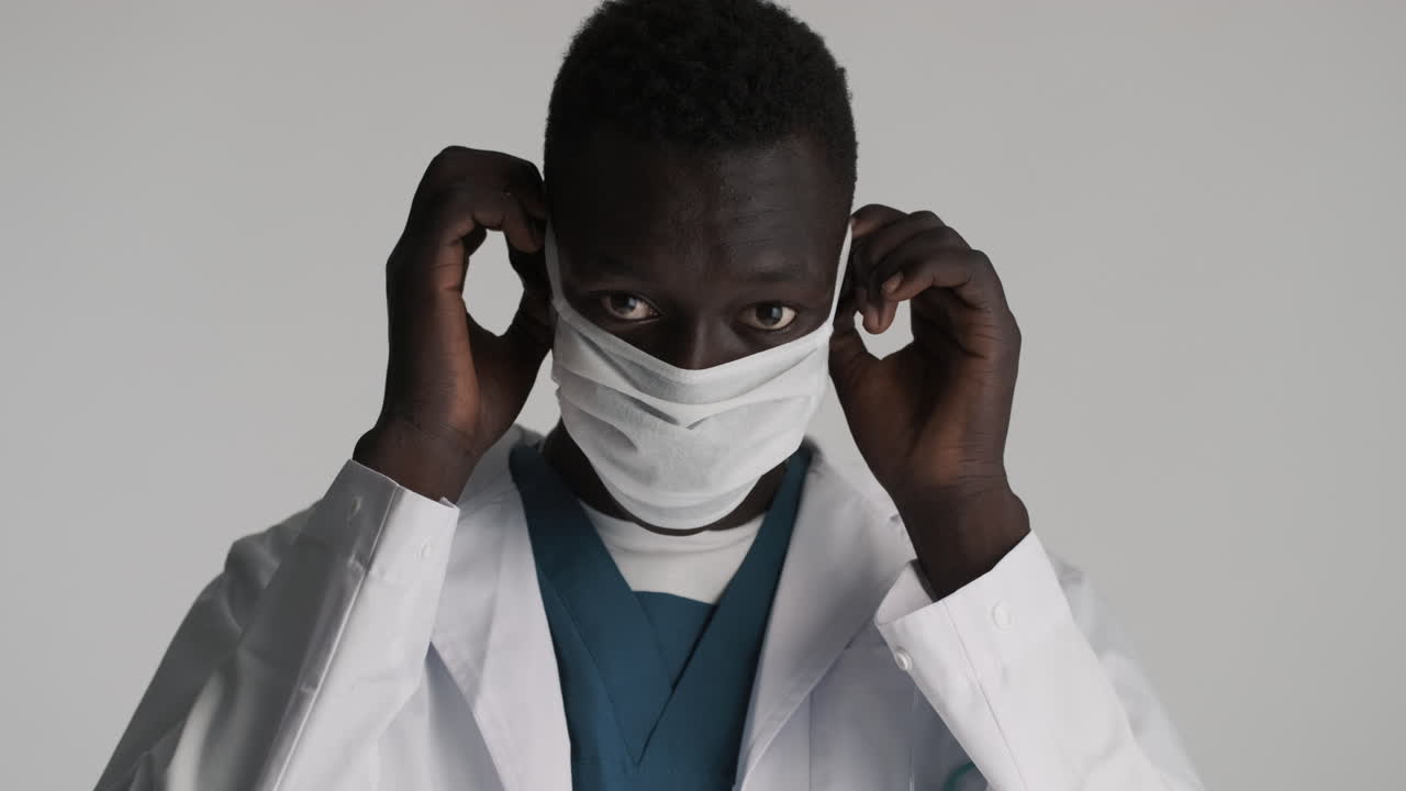African american doctor on grey background.