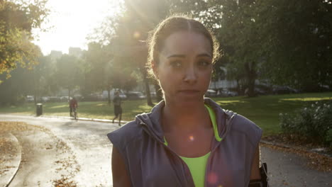 runner woman running in park exercising outdoors fitness tracker wearable technology