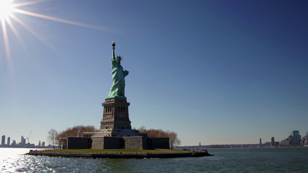 Wide-angle video shot of the Statue of Liberty from a low perspective, capturing the monument