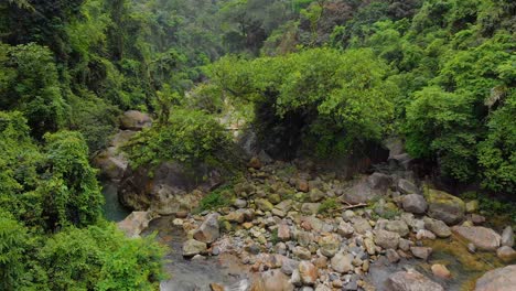 4k-Aerial-flying-Forward-Shot-of-people-walking-on-the-suspension-bridge-in-the-forest-of-Cheerapunji,-Meghalaya,-India