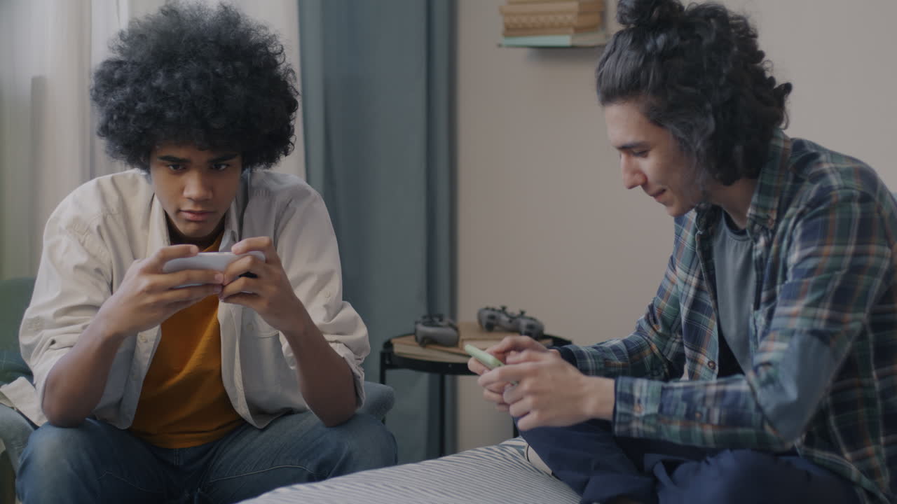 Teenagers Playing Mobile Games