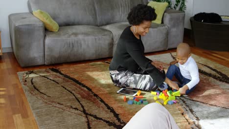 mother and son playing with building blocks in a comfortable home 4k