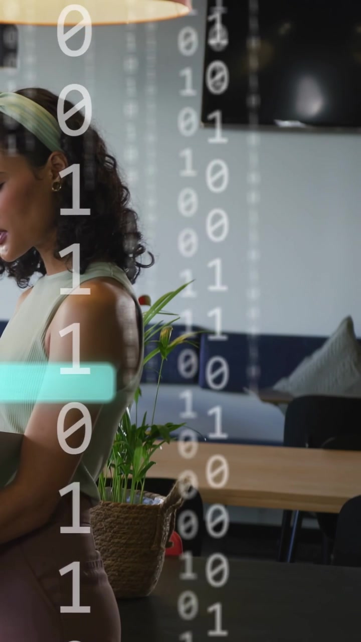 Vertical video: Woman holding laptop pausing, reading tech data in lounge as teal panels animating