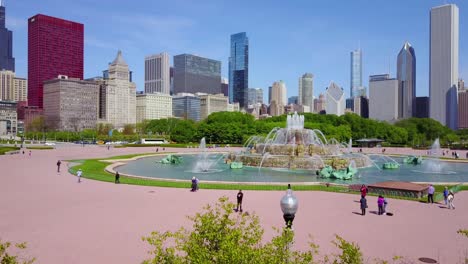 beautiful rising aerial shot of downtown chicago with fountain foreground