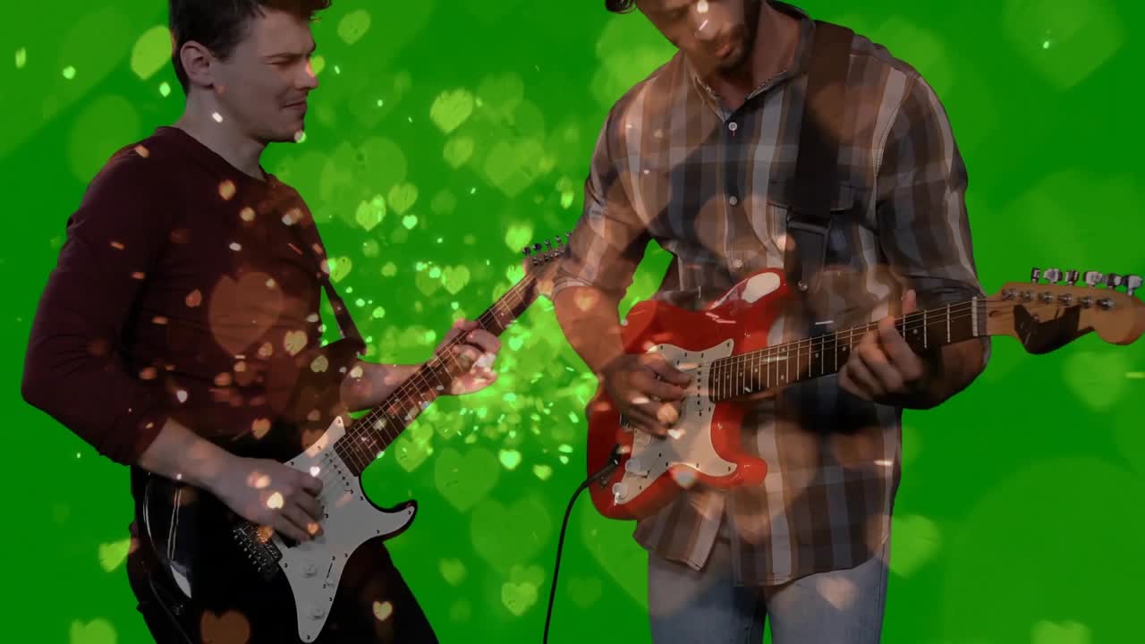 Dita che premono i tasti, strimpellando musica, chitarristi che suonano insieme mentre cuori pulsano su uno schermo verde