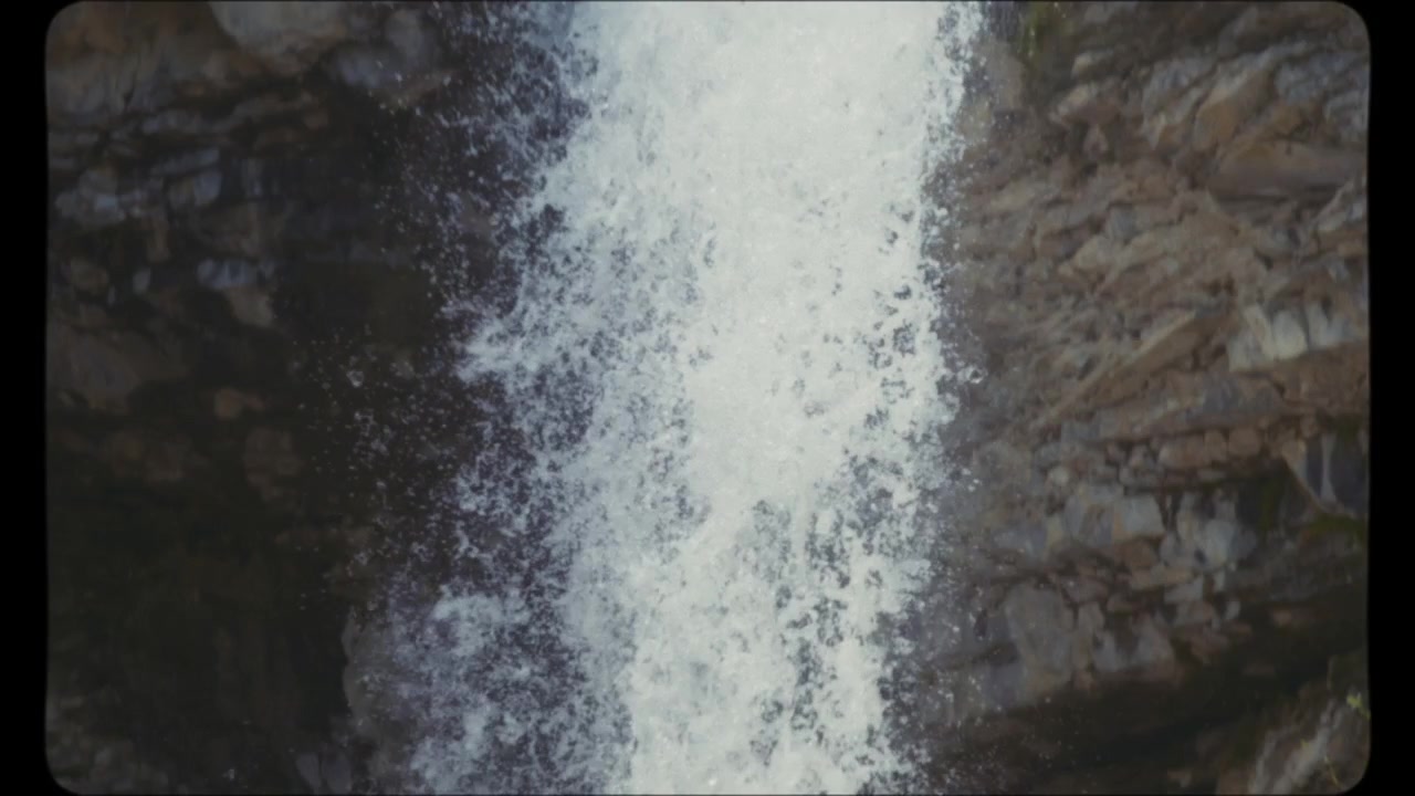 Waterfall splashes into the river