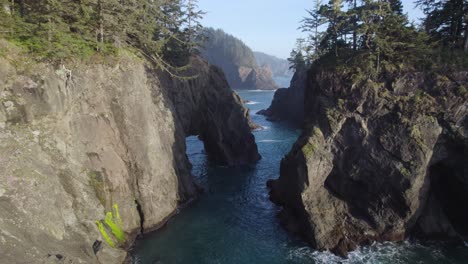 natural bridges arch in brookings, oregon coast in pnw - aerial drone view