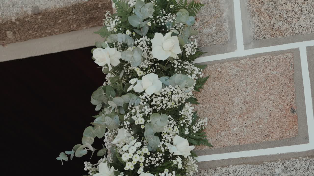 White roses and greenery forming a delicate decorative floral display