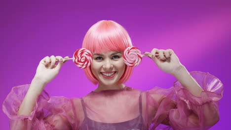 close up of young woman wearing a pink wig