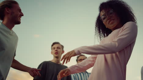 smiling african girl dancing at disco. multiethnic people having fun at party