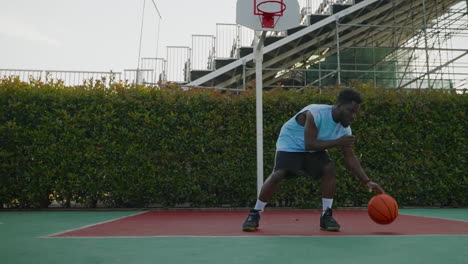 man playing basketball outdoors