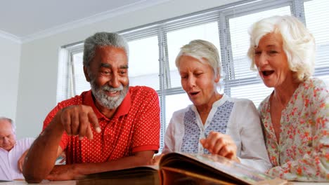 Front-view-of-active-Caucasian-senior-people-looking-at-photo-album-in-nursing-home-4k