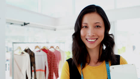 Smiling-fashion-designer-standing-with-arms-crossed-in-office-4k