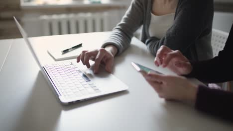 female hands using keyboard notebook. woman hands using mobile phone