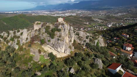 strategic citadel: ancient petrela castle, perched on a massive rock, overlooking majestic mountains in a commanding position for battle