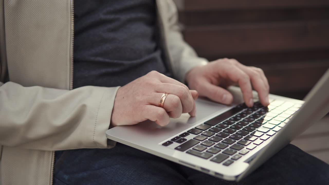 Man working on a laptop outdoors