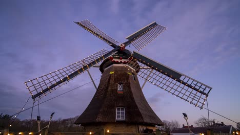 Holiday-lights-glowing-on-a-Windmill-House-in-Ameland,-Netherlands--timelapse