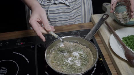 finishing the seasoning of cafe paris butter with aromatic herbs