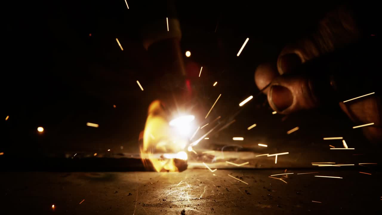 Close-up of welder using welding torch