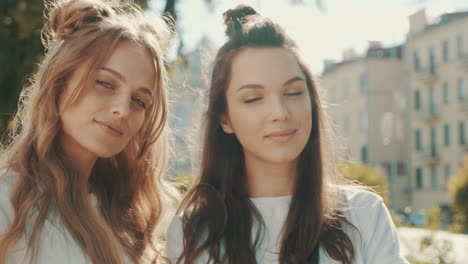 two happy women posing outdoors