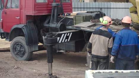 construction workers with crane and truck