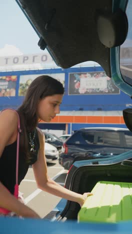 woman loading car trunk with cargo