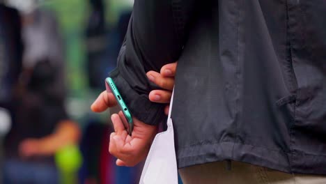 la mano del hombre sostiene el teléfono inteligente en la parte posterior