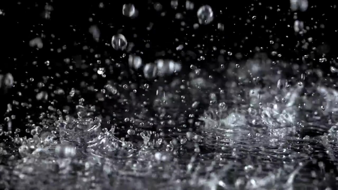 Slow Motion Rain Droplets Splashing on a Black Surface