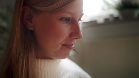 closeup of a young woman reading a book in a cozy atmosphere