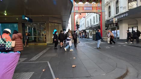 people crossing road at busy melbourne intersection