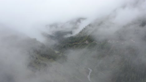 flying through the fog and clouds over the mountains, forest and valley in siguniangshan, xiaojin, sichuan, china