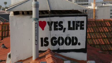 yes, life is good sign behind the chimney in lisbon, portugal