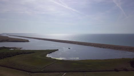 Wide-aerial-tracking-forward-to-the-fleet-lagoon-at-the-west-end-of-the-shingle-beach