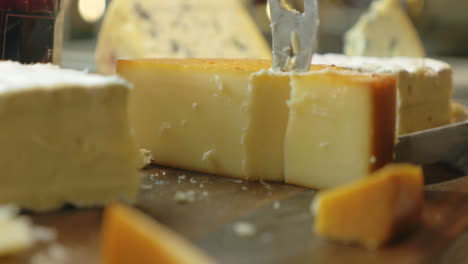 cutting a serving from the cheese