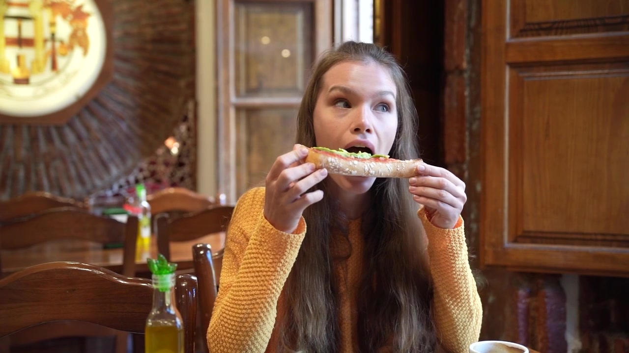 Young woman enjoys a cozy caf moment with olive oil and coffee