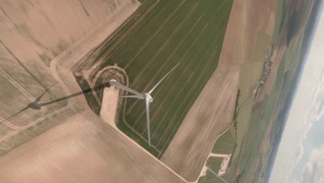 a dynamic dive of a wind-turbine with a cinematic fpv drone, france