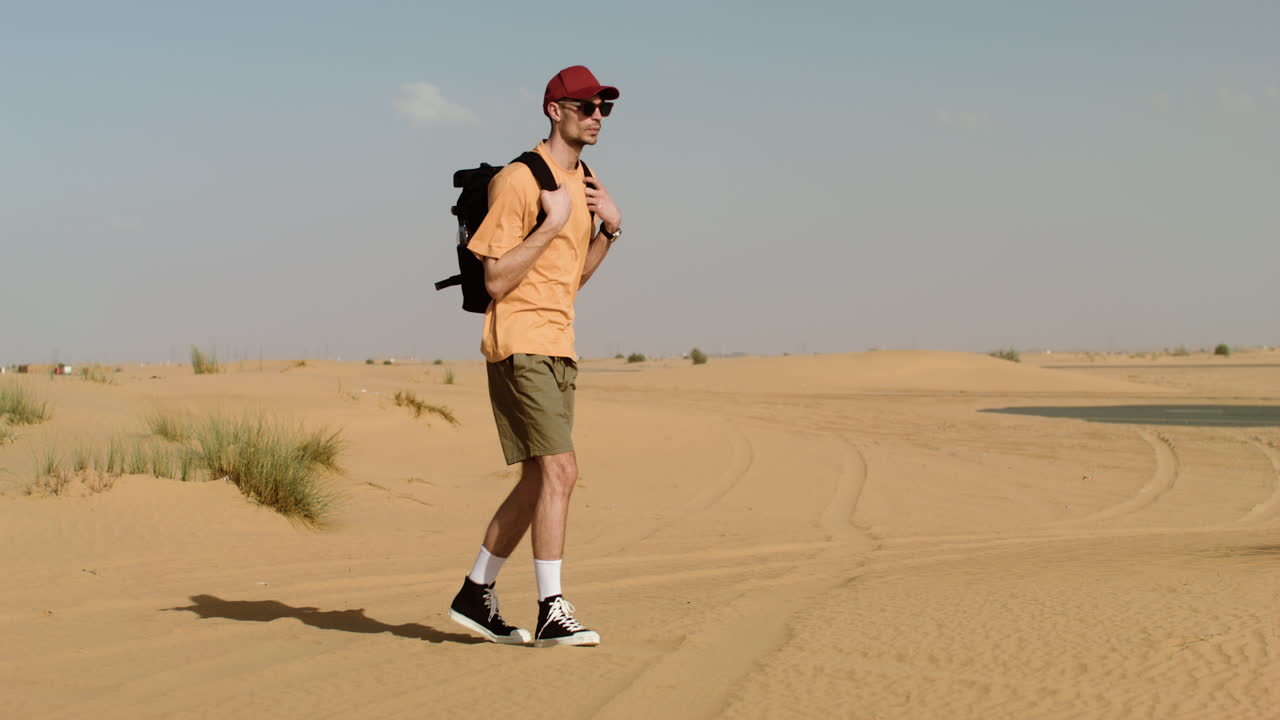 Man with black backpack walking
