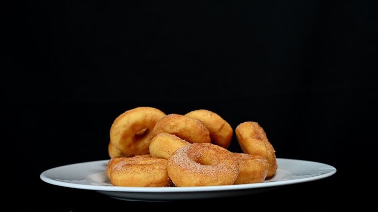 Donuts in plate being picked up.