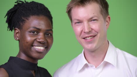 two young multi-ethnic business couple smiling together
