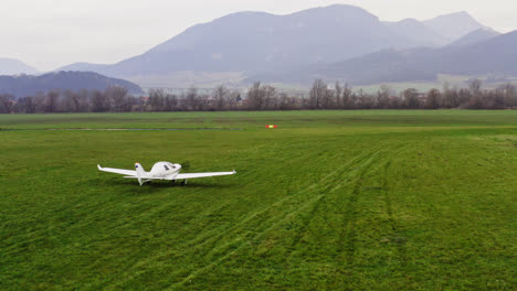 Small-air-plane-travelling-down-a-runway-preparing-for-takeoff-in-the-foggy,-rural-countryside-of-Slovakia