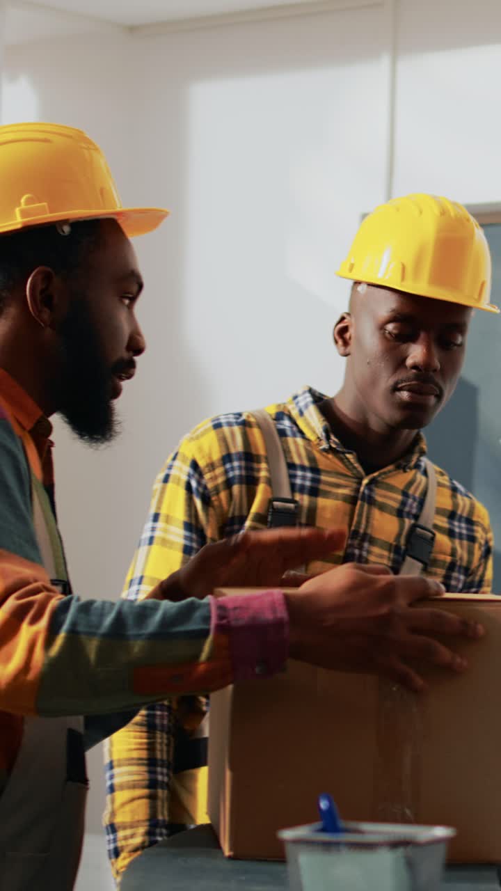 Vertical video: African american workers looking at boxes of products