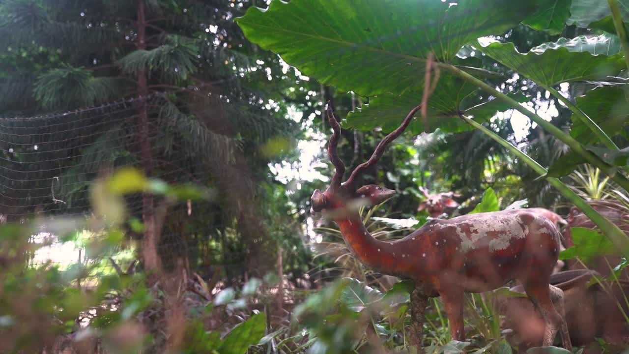 Deer statue surrounded by trees