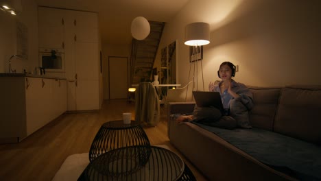 woman working from home at night on laptop