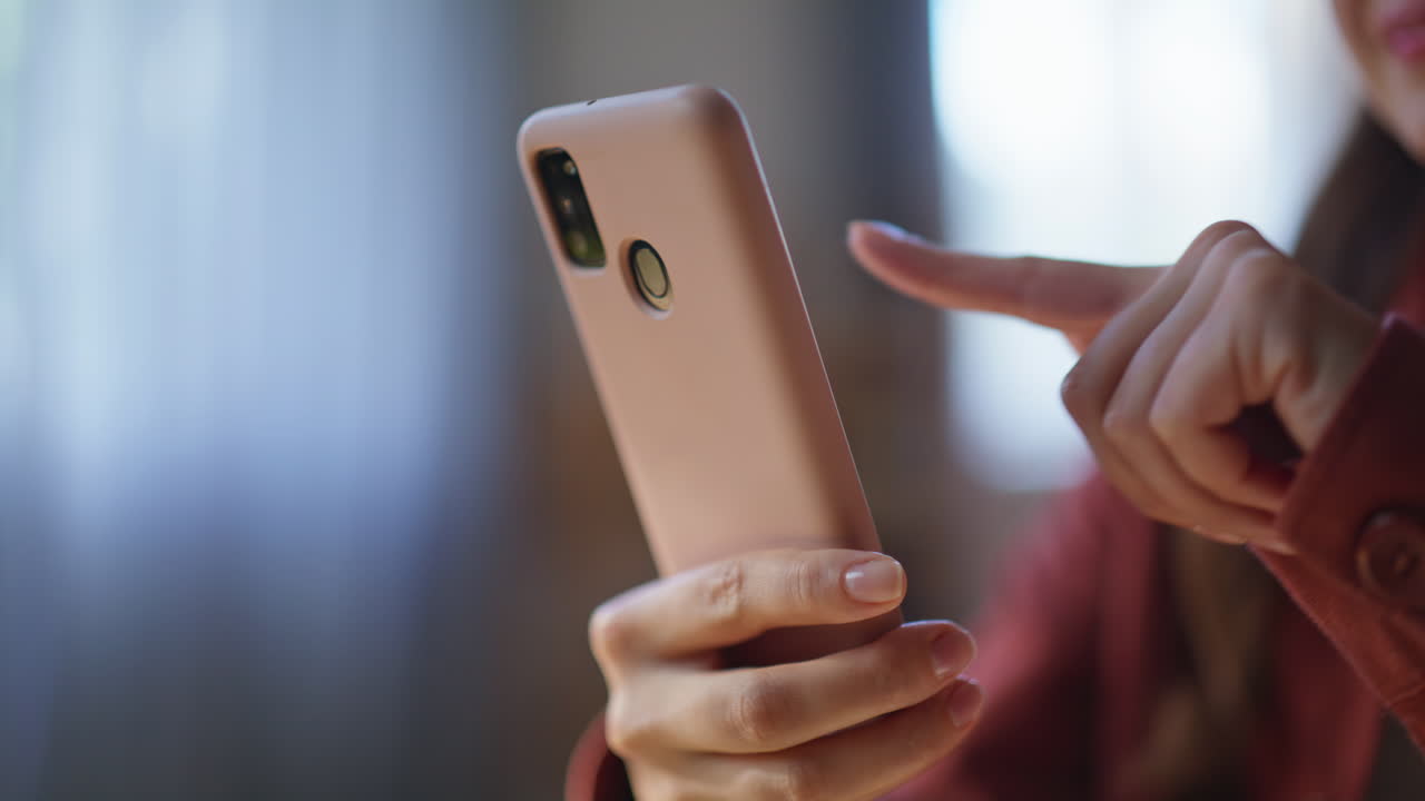 Lady hand touching smartphone screen at home closeup. Unknown woman browsing