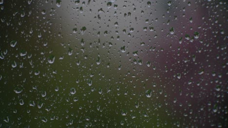 raindrops running down a sheet of glass give a sense of melancholy calm